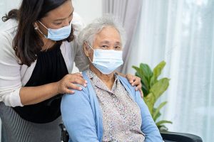 pngtree-asian-senior-with-caregiver-wheelchair-and-face-mask-for-covid19-protection-photo-image_39988034
